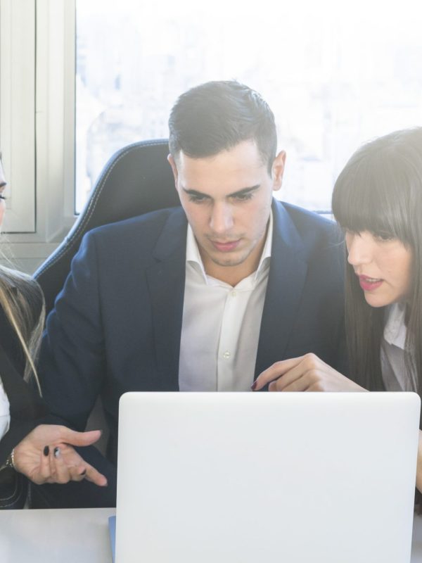 business-people-looking-laptop-having-discussion-meeting