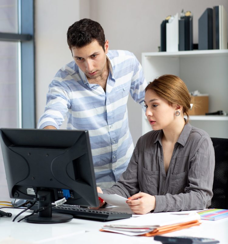front-distanced-view-young-beautiful-lady-grey-shirt-talking-discussing-something-with-young-man-inside-office-daytime-building-job-activity